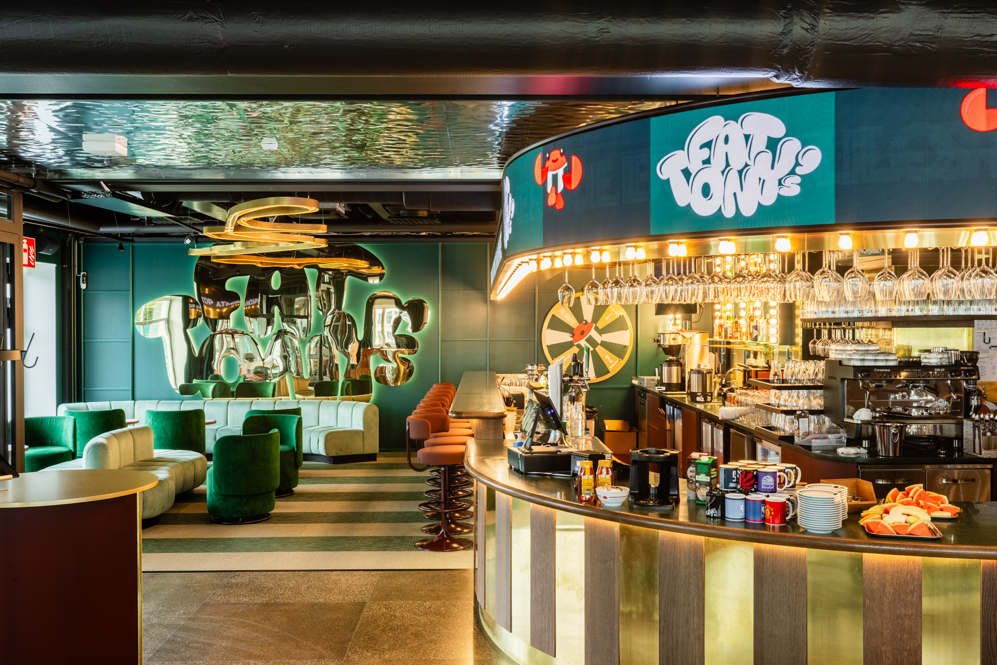 The bar and green seating at Fat Tony's Helsinki