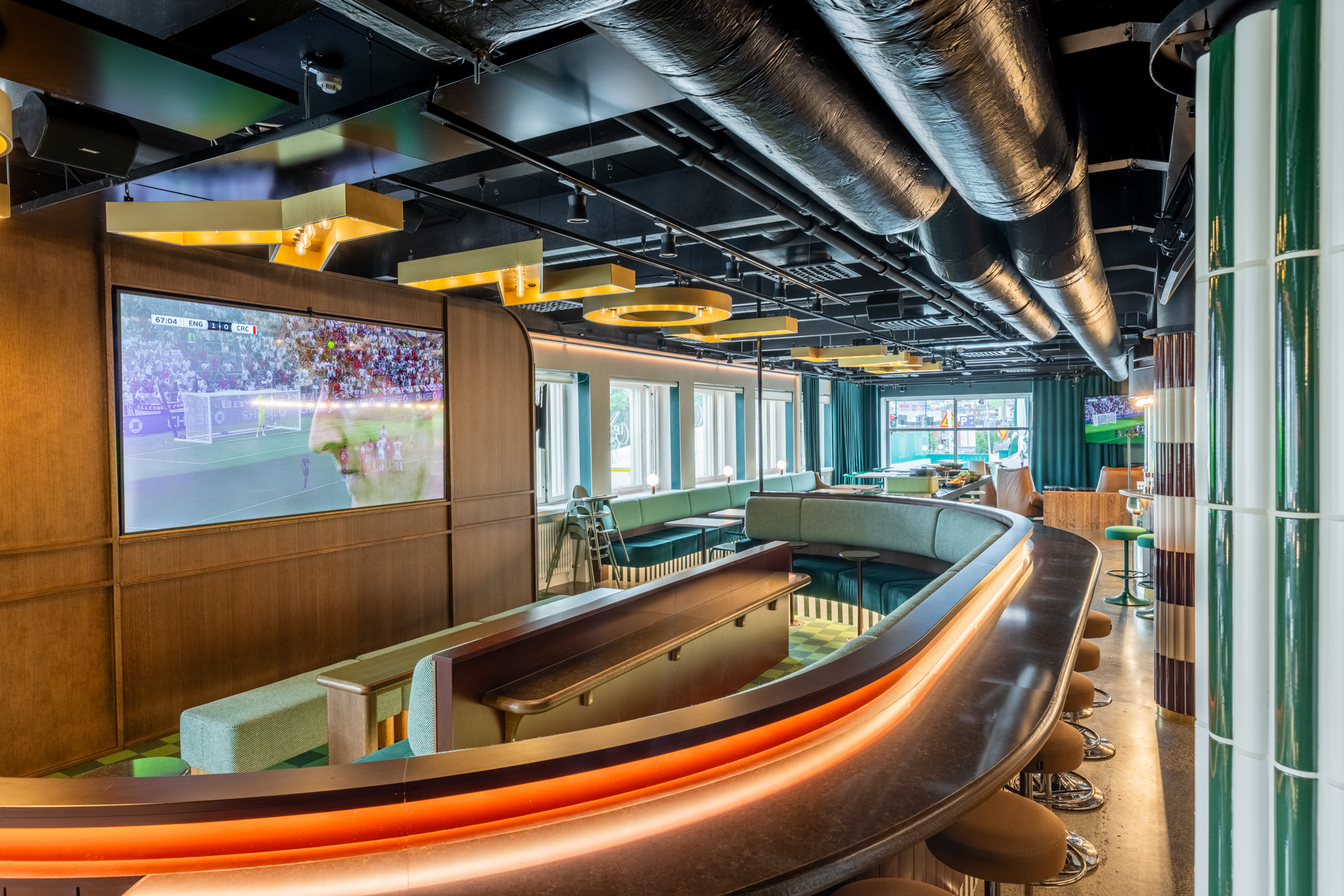 Fat Tony's Helsinki interior with curved seating and warm wood finishes