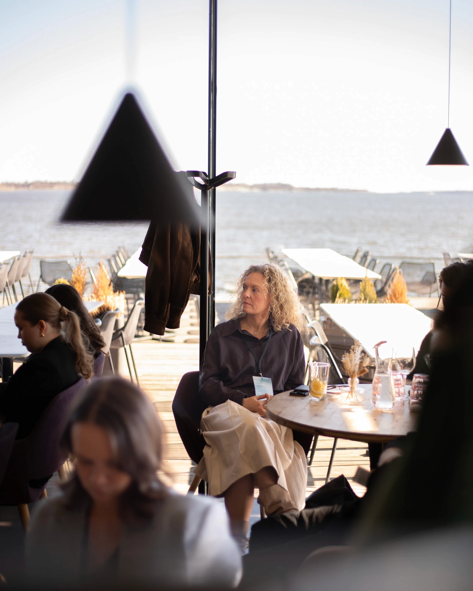 Guests gathered around a table overlooking the sea